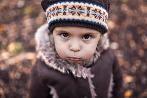 Portrait of pouting little girl in autumn stock photo