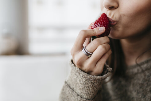 Woman's hand holding strawberry, close-up - JRFF000302