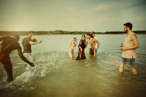 Germany, Haltern, group of friends standing in water of Lake Silbersee having fun together - GDF000949