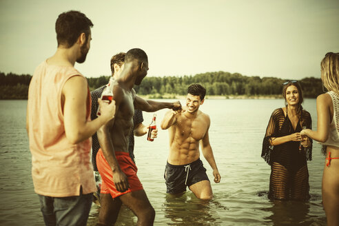 Germany, Haltern, group of friends standing in water of Lake Silbersee having fun together - GDF000951