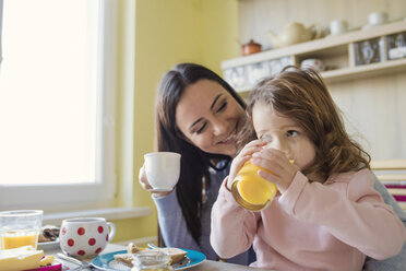 Mother and her little daughter together at breakfast table - HAPF000121