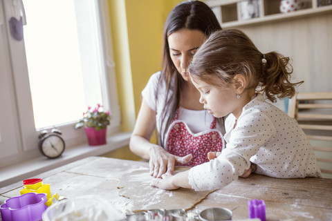 Mother and little daughter baking together stock photo