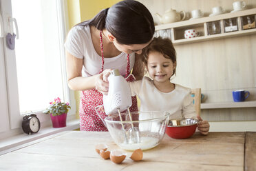 Portrait of smiling little girl and her mother baking together - HAPF000161
