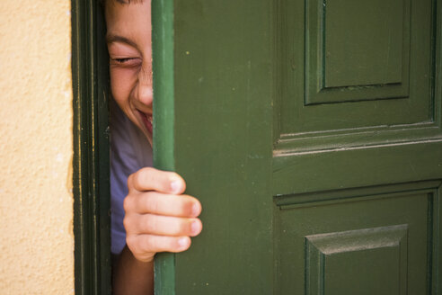 Boy hiding behind a green door - SIPF000069