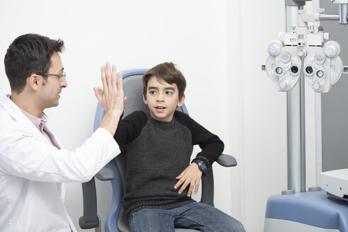 Optiker untersucht die Sehkraft eines Jungen - ERLF000104