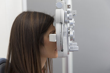 Woman at the optometrist making an eye test - ERLF000114