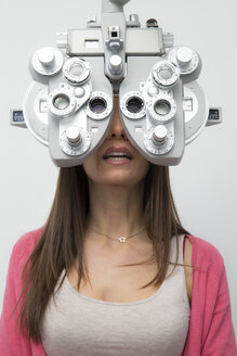 Woman at the optometrist making an eye test - ERLF000115