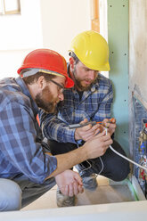 Two plumbers at work on construction site - LAF001589