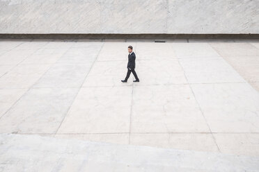 Businessman wearing black suit passing - SIPF000080