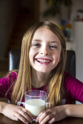 Portrait of happy girl with glass of milk - SARF002455