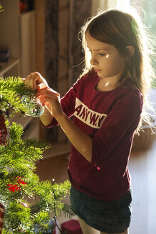 Mädchen schmückt Weihnachtsbaum - SARF002465