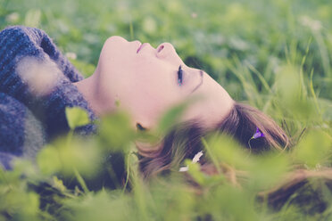 Woman with closed eyes lying on a meadow - SIPF000097