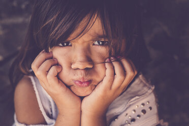 Portrait of girl pouting mouth with head in her hands - SIPF000101
