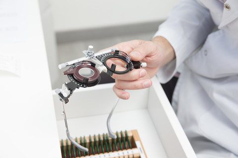 Optometrist, optician doctor working stock photo