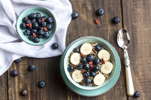 Blueberry muesli with wolfberries and banana slices stock photo
