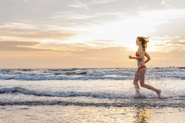Frau im Bikini beim Joggen am Meer - DIGF000011