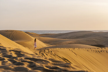 Woman walking over sand dunes - DIGF000019