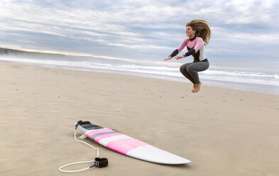 Young surfer woman on the beach - MGOF001288