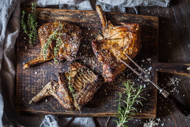 Baked rabbit legs on plate, thyme, rosemary and salt - SBDF002645