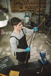 Young mechanic working in repair garage - RAEF000799