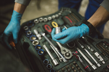 Young mechanic taking tool from tool box, close up - RAEF000804