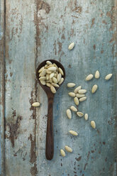 Wooden spoon and almonds on wood - ASF005818