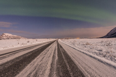 Norway, Lofoten Islands, Northern light over a road in winter - LOMF000194