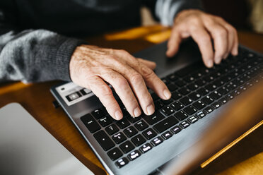 Hands of senior man using laptop, close-up - JRFF000364