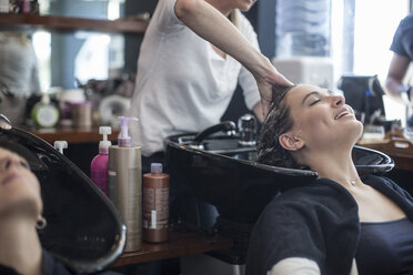 Woman in hair salon getting hair washed - ZEF008200