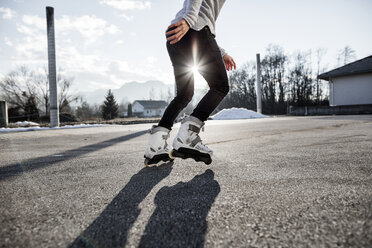 Low section of young man inline skating - DAWF000496