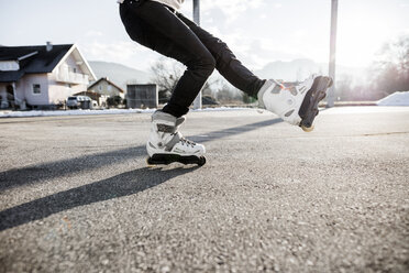 Low section of young man inline skating - DAWF000497