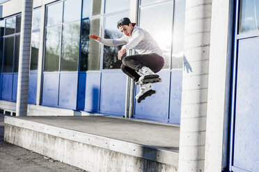 Young man doing a trick on inline skates - DAWF000502