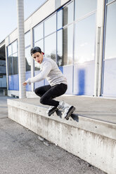 Young man doing a trick on inline skates - DAWF000504