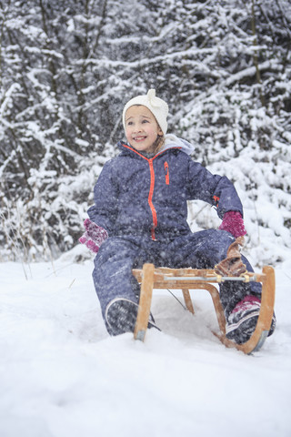 Portrait of girl sledging in the forest stock photo