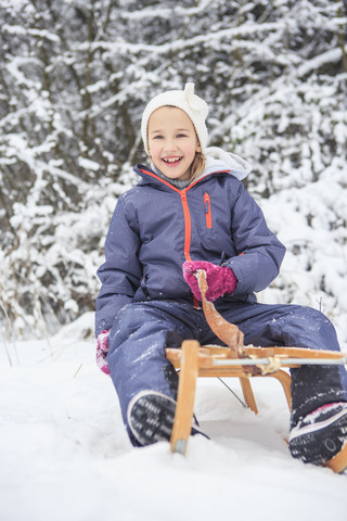 Portrait of girl sledging in the forest stock photo