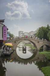 China, Shanghai, Bridge with tourists in Qibao Ancient Town - NKF000448