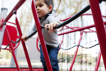 Toddler playing on red playground equipment - VABF000108