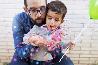 Father and his little son blowing confetti - VABF000114