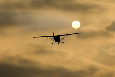 Germany, Hesse, Sports plane Cessna 152 in the evening - AMF004732