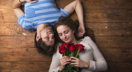 Young couple in love lying on wooden floor - HAPF000196