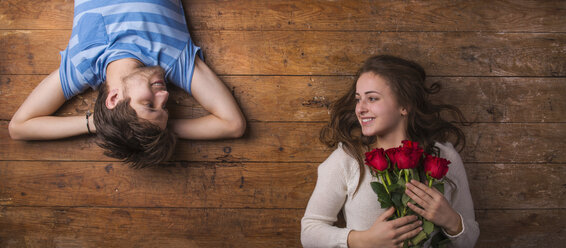 Young couple in love lying on wooden floor - HAPF000197