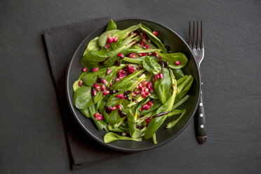 lamb's lettuce and pomegranate seeds in bowl - SARF002516