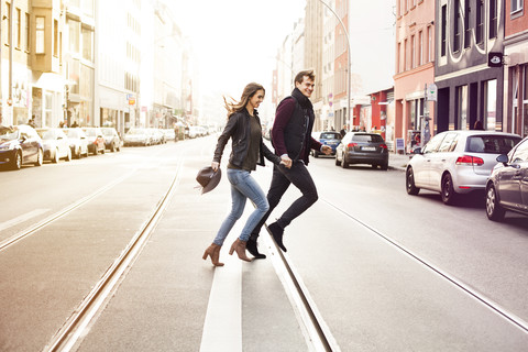 Germany, Berlin, happy couple crossing a street stock photo