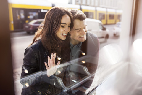 Young couple looking in shop window stock photo