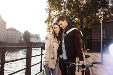 Germany, Berlin, young couple hugging at River Spree - GCF000158