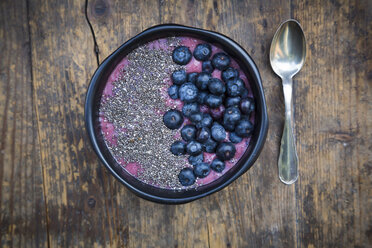 Blueberry smoothie with chia seeds in bowl, fresh blueberries - LVF004500
