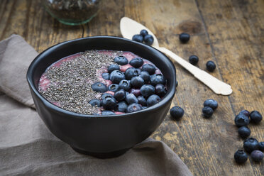 Blueberry smoothie with chia seeds in bowl, fresh blueberries - LVF004503