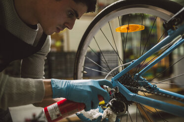 Mechanic oiling a bike chain - RAEF000827