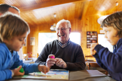 Senior man playing with his grandsons stock photo