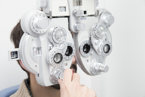 Man at the optometrist making an eye test stock photo